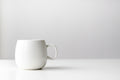 White glazed porcelain mug on a bright table
