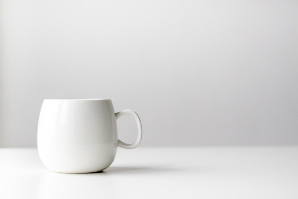White glazed porcelain mug on a bright table